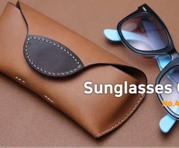 Футляр для солнцезащитных очков ручной работы из коричневой кожи с парой синих и черных солнцезащитных очков, лежащих рядом на коричневой поверхности, на заднем плане надпись "Футляр для солнцезащитных очков №40 PDF".